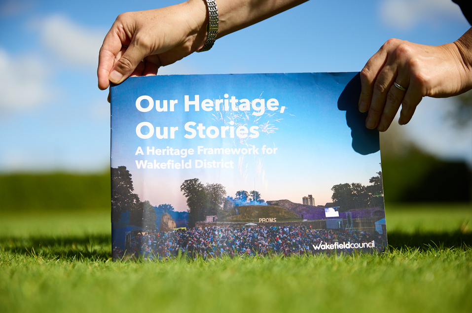 A publication on a chair seat, titled "Our Heritage, Our Stories"